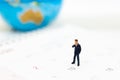 Miniature people : Businessman standing on the calendar to set the date for the meeting . Image use for business meetings concept Royalty Free Stock Photo