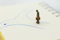 Miniature people: Businessman standing in front of arrow pathway choice. Image use for Business decision concept Royalty Free Stock Photo