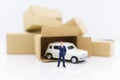 Miniature people: Businessman standing with white car. Work and save money to buy a car. Image use for saving money Royalty Free Stock Photo