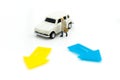 Miniature people: Businessman standing with white car. Work and Royalty Free Stock Photo