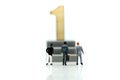 Miniature people : Businessman standing with wooden number of 1,to be the first,Business competition Concept.