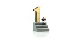 Miniature people : Businessman standing with wooden number of 1,to be the first,Business competition Concept.