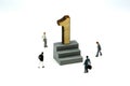 Miniature people : Businessman standing with wooden number of 1,to be the first,Business competition Concept.