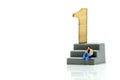 Miniature people : Businessman standing with wooden number of 1,to be the first,Business competition Concept.