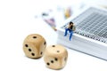 Miniature people : businessman throwing dice and sitting on play Royalty Free Stock Photo