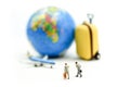 Miniature people : Businessman walking with Suitcase,mini worldmap, and airplane,travel concept Royalty Free Stock Photo