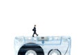 Miniature people : Businessman walking on tape cassette,music le