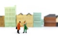 Miniature people: Businessmen handshake in front of wooden block with house, agreement, partnership and business concept Royalty Free Stock Photo