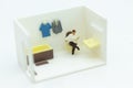 Miniature people : Businessmen read newspapers on the toilet, daily routine, personal errands in the bathroom