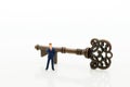 Miniature people: Businessmen stand with keys. Image use for key man, the key to success, business concept Royalty Free Stock Photo