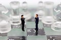 Miniature people, Businessmen stand on opposite sides of the chess game, separate party , benefit, use as a business competition Royalty Free Stock Photo