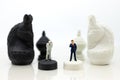 Miniature people, Businessmen stand on opposite sides of the chess game, separate party , benefit, use as a business competition Royalty Free Stock Photo