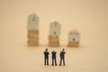 Miniature 3 people businessmen standing with back Negotiating in business. as background business concept and strategy concept Royalty Free Stock Photo