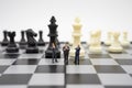 Miniature people businessmen standing on a chessboard with a chess piece on the back Negotiating in business. as background Royalty Free Stock Photo