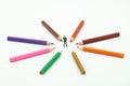 Miniature people businessmen standing Colorful wooden pencils surround a circle on a white background. Make a center Can be used Royalty Free Stock Photo