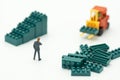 Miniature people businessmen standing with High-lifted forklift trucks are a great way to grow your business as a high-tech, high-