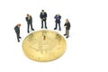 Miniature people businessmen standing Investment Analysis gold bit coin . Communications to Invest in the Digital Market.using as Royalty Free Stock Photo