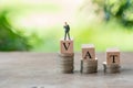 Miniature people businessmen standing on wood word VAT placed on Royalty Free Stock Photo