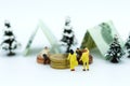 Miniature people: Camping for the holidays in nature. Image use