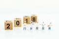 Miniature people: Chef standing with wooden block 2018. Image use for create idea for food production of the year