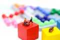 Miniature people : Child having fun to play slider on Colorful Royalty Free Stock Photo