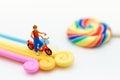 Miniature people : Children with colorful of candies and lollipops. Image use for education and food concept Royalty Free Stock Photo