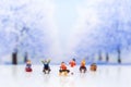 Miniature people: Children playing on snow funny together. Image use for Christmas festival.