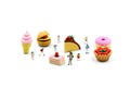 Miniature people : children,student with dessert.fun and food co Royalty Free Stock Photo