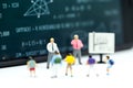 Miniature people : children and teacher with math blackboard background. Back to school concept.