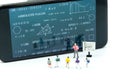 Miniature people : children and teacher with math blackboard background. Back to school concept.