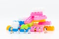 Miniature people: Childrens with colorful puzzle piece. Image use for child`s toy, education concept Royalty Free Stock Photo