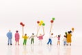 Miniature people: Childrens play balloon together wiht fun, using as background International day of families concept Royalty Free Stock Photo