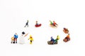 Miniature people: Childrens playing fun with snow slider