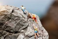 Miniature people: Climber looking up while climbing challenging