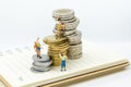 Miniature people: Climbers are climbing coins. Image use for moving forward to success, business concept