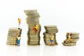 Miniature people: Climbers are climbing coins. Image use for moving forward to success, business concept