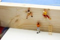 Miniature people. : climbing ladders to get to the top of the po