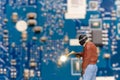 Miniature people Computer repair technicians repair an electronic board with gas Royalty Free Stock Photo