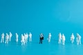 Miniature people concept - a different business worker standout from the crowd Royalty Free Stock Photo