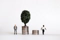 Miniature people. The concept of racial wage disparity. Royalty Free Stock Photo