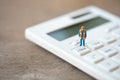 Miniature people Construction worker Keypad TAX button For tax calculation. Easy to calculate. on White calculator on white Royalty Free Stock Photo