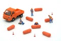 Miniature people Construction worker Load up the car model orange capsule medicine. on white background using as background