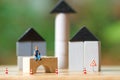 Miniature people Construction worker sitting on wood Investment Analysis Housing Or investment in movable property. using as backg Royalty Free Stock Photo