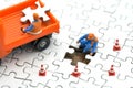 Miniature people Construction worker on white Jigsaw. using as background business concept and finance concept with copy space fo