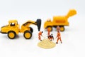 Miniature people: Construction workers building plans , have building materials, sand, brick, mortar. Use image for construction Royalty Free Stock Photo