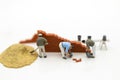 Miniature people: Construction workers building plans , have building materials, sand, brick, mortar. Use image for construction