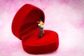 Miniature people: Couple hug each other to show love on wedding ring box. Image use for Valentine`s day concept Royalty Free Stock Photo