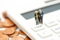 Miniature people : Couple oldman standing with Calculator,business,tax concept.