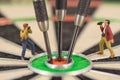 miniature people with dart in bull& x27;s eye, close up Royalty Free Stock Photo