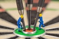 miniature people with dart in bull& x27;s eye, close up Royalty Free Stock Photo